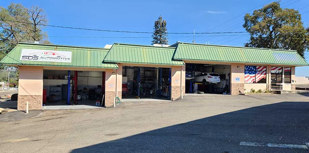 Auto repair shop with garage doors open.